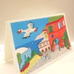 Amalfi paper postcard with illustration in Vietri ceramic style of the Ravello panorama.