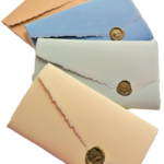 Amalfi paper gift boxes. Each pack contains 10 sheets 13x8 and 10 envelopes 14x9 enclosed by a sheet of LR line sealed with sealing wax. Available in different colors.