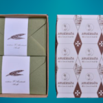 Gift box containing coloured envelopes and wedding invitation cards in ivory Amalfi paper