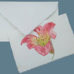 Wedding invitations made with Amalfi paper decorated with a watercolor lily created by Lo Scrigno di Santa Chiara.