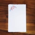 Ivory Amalfi paper invitation card decorated with cherry blossoms