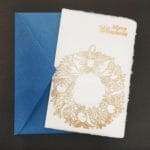 Amalfi paper Christmas cards with gold embossed decorations handmade by Lo Scrigno di Santa Chiara. The decoration represents a typical Christmas wreath.